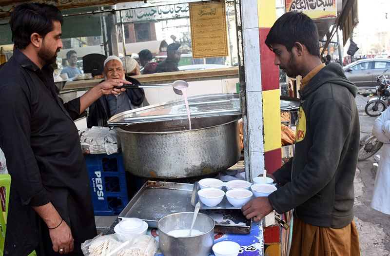 A shopkeeper serves pink tea to customers as demand rises with the onset of winter (APP)